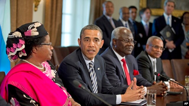 President Barack Obama in the Cabinet Room of the White House after a meeting with, from left, Malawi President Joyce Banda; Sierra Leone President Ernest Bai Koroma; and Cape Verde Prime Minister José Maria Pereira Neves, March 28, 2013. (AP Photo/Manuel Balce Ceneta)