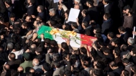 Iranian mourners carry the flag draped coffin of Gen. Hassan Shateri, during a funeral ceremony, in Tehran, Iran, February 14, 2013. 