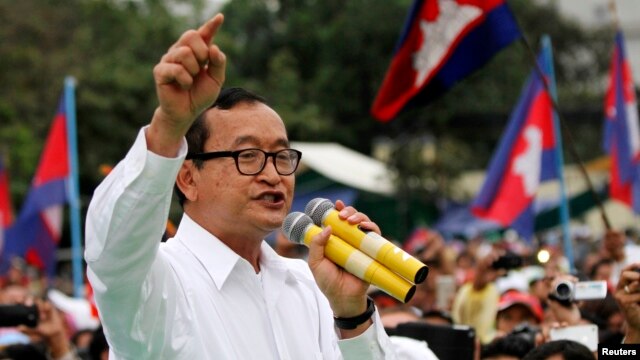 FILE - Sam Rainsy (C), leader of the opposition Cambodia National Rescue Party is seen speaking at a protest in central Phnom Penh.