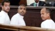 FILE - Al-Jazeera English producer Baher Mohamed, left, Canadian-Egyptian acting Cairo bureau chief Mohammed Fahmy, center, and correspondent Peter Greste, right, appear in court during their trial on terror charges, in Cairo, Egypt. 