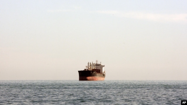 A cargo ship is seen between the Iranian city port of Bandar Abbas and Qeshm Island in the strategic waterway the Persian Gulf.
