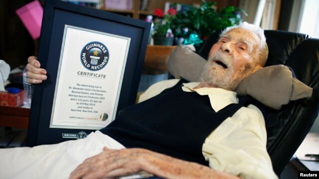 111-year-old Alexander Imich holds a Guinness World Records certificate recognizing him as the world's oldest living man during an interview with Reuters at his home on New York City's upper west side, May 9, 2014. Dr. Imich, who holds a Ph.d in Zoology, was born in Poland on February 4, 1903, fled Poland when the Nazis took over in 1939, survived a slave labor camp in Russia and moved to the United States in 1951 where he became an author on parapsychology.