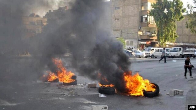 A handout picture released by the Syrian opposition's Shaam News Network on July 17, 2012 shows opponents of the regime blocking the roads with burning tires in Damascus on July 16, 2012.