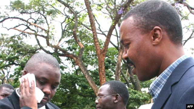 FILE - Erias Lukwago (L) walks with Forum for Democratic Change (FDC) representative Maj. Gen. Mugisha Muntu (R).