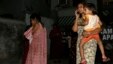Local women who rushed outdoors following tremors speak on their cellphones, in Kolkata, India, April 13, 2016. A strong earthquake struck Myanmar on Wednesday night and was felt in parts of eastern India and Bangladesh.