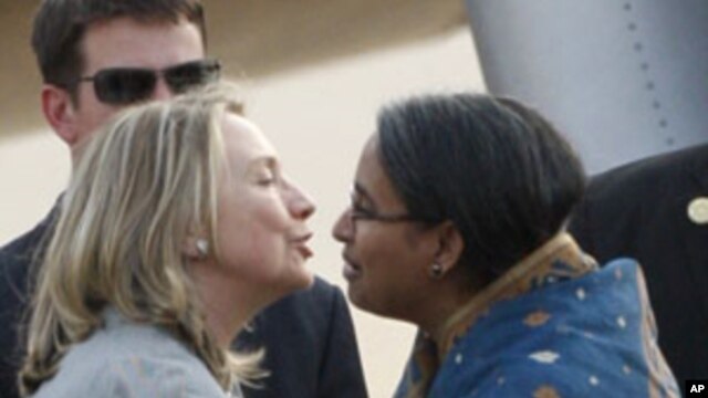 U.S. Secretary of State Hillary Rodham Clinton, left, is greeted by Bangladeshi Foreign Minister Dipu Moni upon her arrival in Dhaka, Bangladesh, May 5, 2012. 