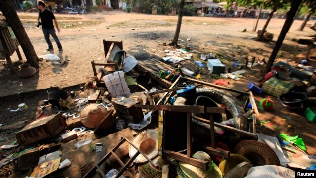 Destroyed furniture and belongings are seen in a market in Sit Kwin, Burma, March 29, 2013. 