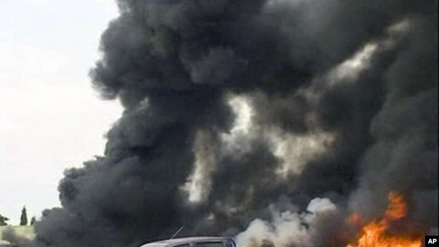 Image taken from APTN footage shows smoke bellowing after an explosion at the police headquarters, in Abuja, June 16, 2011