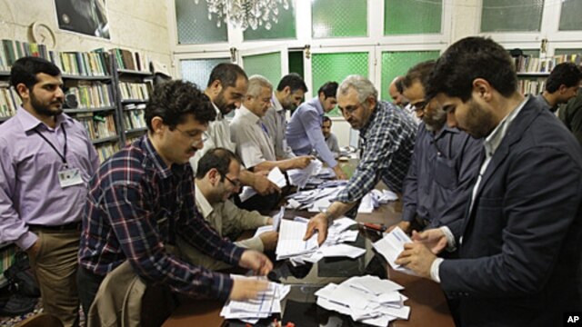 Electoral workers count ballots in a polling station, in Tehran, Iran, May 4, 2012. 
