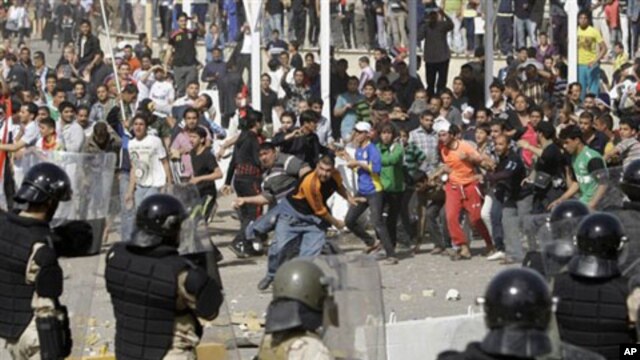 Iraqi riot police officers prevent anti-government protesters from entering the heavily guarded Green Zone during a demonstration in Baghdad, February 25, 2011