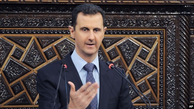 In this photo released by the Syrian official news agency SANA, shows Syrian President Bashar Assad, as he delivers a speech at the parliament in Damascus, June 3, 2012.