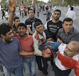 Bahrainis carry a wounded anti-government protester in Manama during the first wave of the crackdown, February 18, 2011