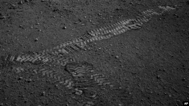 This NASA image shows the Curiosity rover's wheel tracks on the surface of Mars, from an image sent from one of the rover's cameras, August 22, 2012.