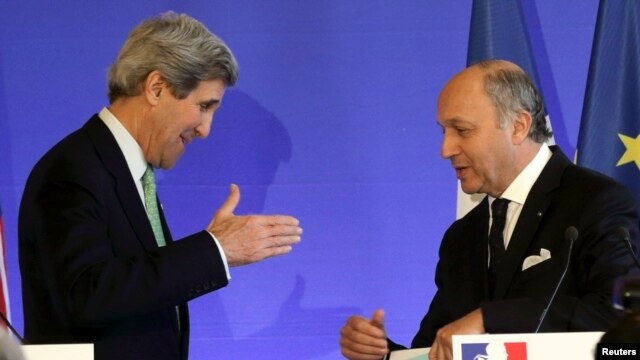 French Foreign Affairs minister Laurent Fabius (R) speaks with U.S. Secretary of State John Kerry following a news conference at the ministry in Paris, February 27, 2013.  REUTERS/Philippe Wojazer  (FRANCE) - RTR3ECNE