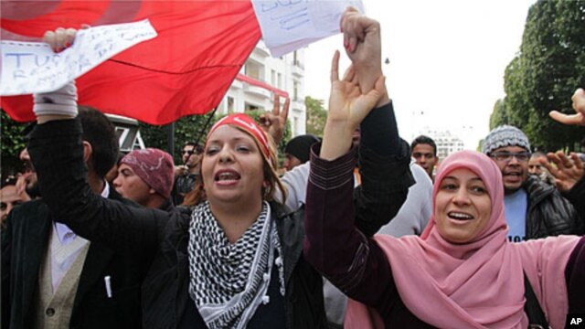 Tunisians are seen celebrating on Habib Bourguiba Boulevard in Tunis marking the one year anniversary of their revolution, Saturday, January 14, 2012.