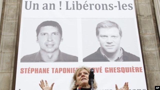 A gathering in support of Herve Ghesquiere and Stephane Taponier, two journalists from France 3 television who are held hostage by the Taliban in Afghanistan, in front Paris city hall, 29 Dec 2010