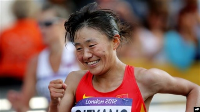 Choeyang Kyi celebrates her third place finish in the women's 20-kilometer race walk at the 2012 Summer Olympics, Saturday, Aug. 11, 2012, in London.  (AP Photo/Emilio Morenatti)
