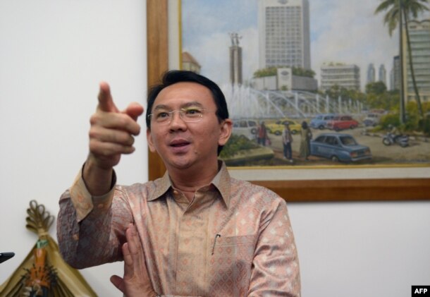 FILE - Then-Jakarta vice governor Basuki Tjahaja Purnama, known by his nickname Ahok, speaks to journalists at his office in Jakarta.
