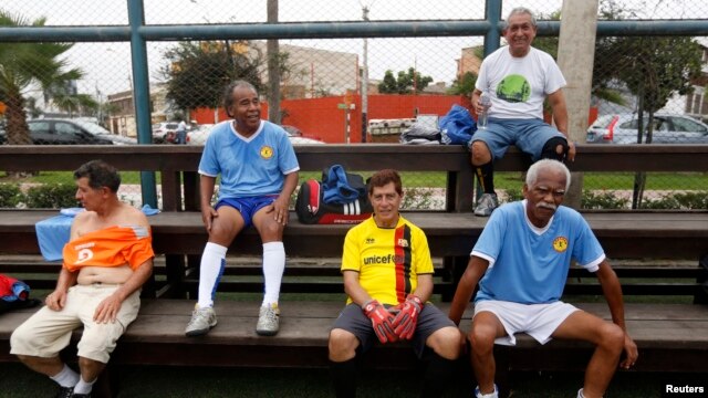 A group of senior soccer players rest after a match in Miraflores, in Lima.