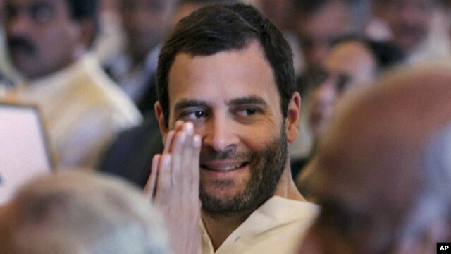 Congress party leader Rahul Gandhi greets attends the swearing-in ceremony for the new ministers in New Delhi, India, October 28, 2012. 