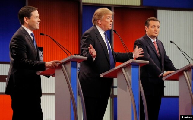 Republican U.S. presidential candidate Donald Trump gestures towards rivals Marco Rubio (L) and Ted Cruz (R) at the U.S. Republican presidential candidates debate in Detroit, Michigan, March 3, 2016.