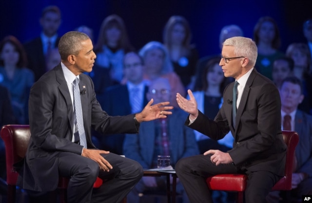 President Barack Obama, left, speaks during a CNN televised town-hall meeting hosted by Anderson Cooper, right, at George Mason University in Fairfax, Va., Jan. 7, 2016.