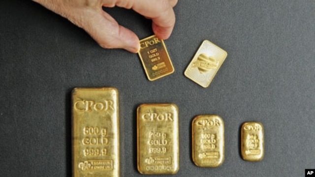 A one-ounce gold bar [top R] designed by fashion designer Jean Paul Gaultier is displayed with gold bars weighing between one ounce and 500 grams in an office of French gold supplier CPoR Devises company in Paris, October 10, 2011.