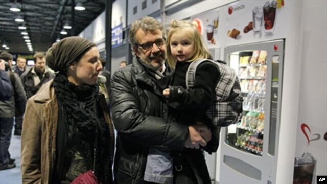 Passengers arrive after being evacuated from Tripoli in crisis-hit Libya at Roissy Charles-de-Gaulle airport, north of Paris France, February 23, 2011