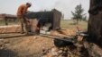A man works at a makeshift oil refinery site in Aleppo