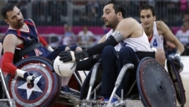 Jason Regier, left, of the United States goes for the ball with Nicholas Rioux of France