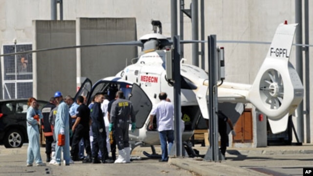 Rescue services evacuate an injured person after an explosion at the Marcoule nuclear waste treatment site killed one person and injured four, southern France, September 12, 2011.