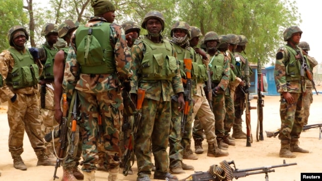 Soldiers stand during a parade in Baga village in the northeastern state of Borno May 13, 2013. 