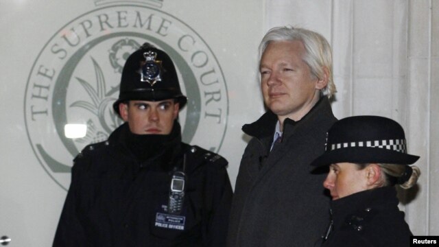 Julian Assange walked by two bobbies in to Supreme Court in London