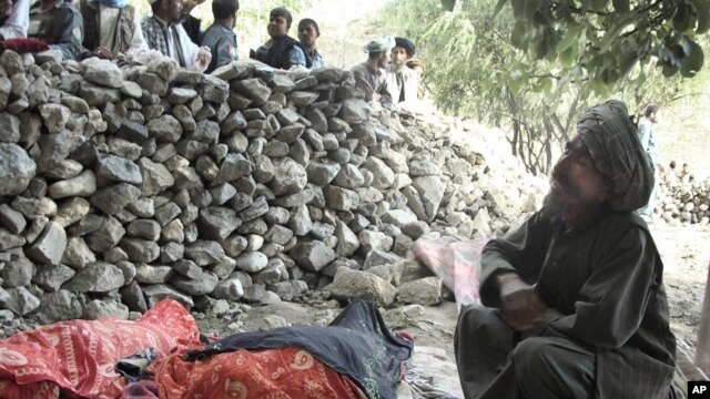 An Afghan man mourns the death of relatives near the site of the earthquake that hit Baghlan province, Afghanistan, June 11, 2012. 