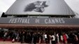 Para pengunjung antri untuk memasuki gedung "The Festival Palace" yang dihiasi poster raksasa Festival Film Cannes ke-66 di Cannes (15/5). Perhiasan senilai $1,4 juta yang akan dipinjamkan kepada para bintang Festival FIlm tersebut dikabarkan raib dari kamar hotel yang dihuni pegawai perempuan perusahaan perhiasan Swiss, Choppard.