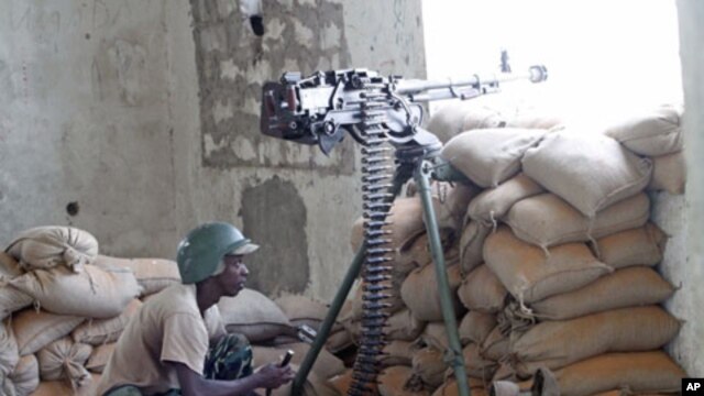 A soldier in the African Union Mission in Somalia takes his position during fighting between Islamists and government forces, in southern Mogadishu, February 14, 2012.