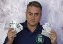 Mayor Luca Sellari displays Filettino's own bank currency - the 'Fiorito' - at his office in Filettino, Italy, August 2011.
