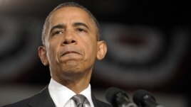 President Barack Obama pauses as he speaks about the Aurora, Colorado shooting at a campaign event in Ft. Myers, Florida, July 20, 2012.