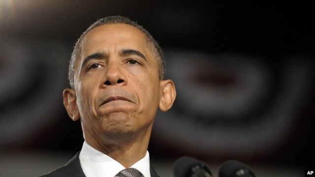 President Barack Obama pauses as he speaks about the Aurora, Colorado shooting at a campaign event in Ft. Myers, Florida, July 20, 2012.