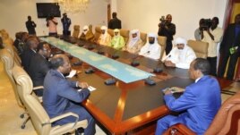 Burkina Faso President Blaire Compaore (R), the top mediator in Mali's crisis, and his delegation meet at the presidential palace in Ouagadougou with rebel leaders (R) from the Islamist Ansar Dine, one of the groups controlling the country's north, June 1