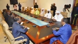 Burkina Faso President Blaire Compaore (R), the top mediator in Mali's crisis, and his delegation meet at the presidential palace in Ouagadougou with rebel leaders (R) from the Islamist Ansar Dine, one of the groups controlling the country's north, June 1