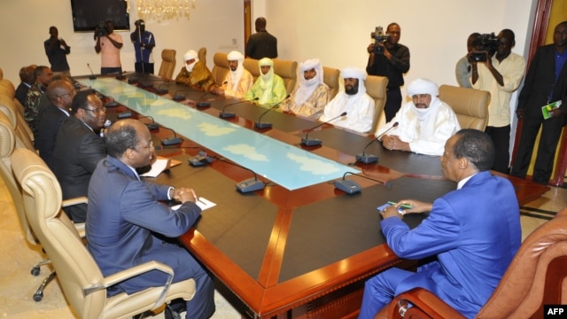 Burkina Faso President Blaire Compaore (R), the top mediator in Mali's crisis, and his delegation meet at the presidential palace in Ouagadougou with rebel leaders (R) from the Islamist Ansar Dine, one of the groups controlling the country's north, June 1