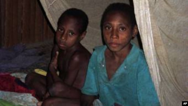 FILE – Mosquito nets helped control malaria after an outbreak in the late 1990s. Today, a mysterious illness initially thought to be malaria has hit Papua, killing at least 41 children within three weeks. 