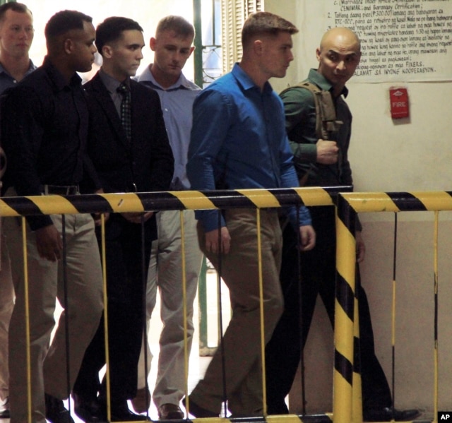 FILE - U.S. Marine Pfc. Joseph Scott Pemberton, third left, is escorted into the courtroom for his scheduled trial, March 23, 2015, at Olongapo city, Zambales province, northwest of Manila, Philippines.