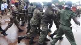Guinean police arrest a protester on September 28, 2009 in front of the biggest stadium in the capital Conakry during a protest banned by Guinea's former ruling junta.