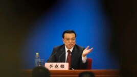 China's newly-elected Premier Li Keqiang gestures during his news conference in Beijing, March 17, 2013.