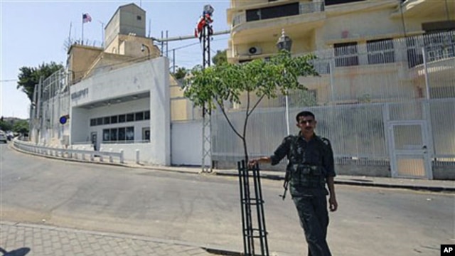A Syrian security man stands guard in front of the U.S. embassy in Damascus, Syria, July 12 2011. (file photo)