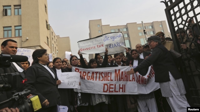 Lawyers shout slogans as they hold placards and a banner during a protest demanding the judicial system act faster against rape, outside a district court in New Delhi, India, January 3, 2013.