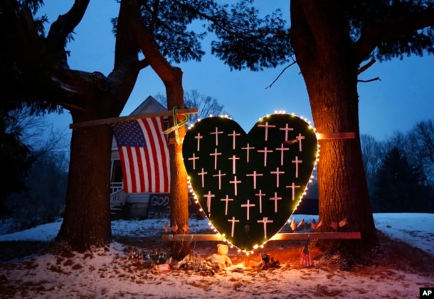 FILE - A makeshift memorial with crosses for the victims of the Sandy Hook massacre stands outside a home in Newtown, Dec. 14, 2013, the one-year anniversary of the shootings.
