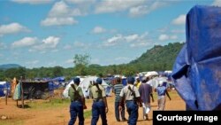 Zimbabwean police on patrol at the Chingwizi transit camp for over 20,000 people displaced as a result of the flooded Tokwe-Mukorsi Dam. (Photo: Human Rights Watch)